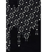 Abstract black hand-tufted wool rug with grey and white dot pattern